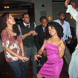 women and men dancing on the dance floor at a big sister boston event