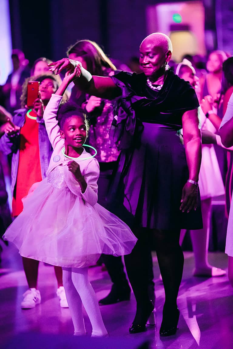 big and little sister dancing on the dance floor