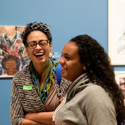 two young women laughing with each other