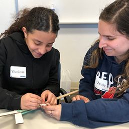 big and little sister performing a craft
